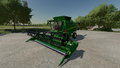 In-game view of John Deere T560 combine harvester with a 625X cutter attached